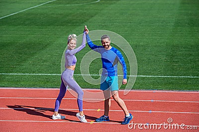 Sport success. male and female coach on stadium running track arena. healthy lifestyle. sport couple celebrate team win Stock Photo