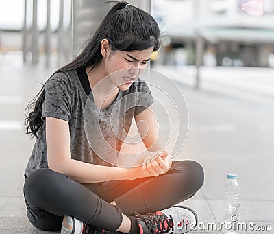 Sport woman having an injury on her wrist hand Stock Photo