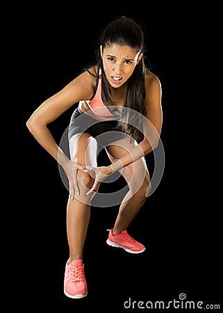 Sport woman holding injured knee suffering pain in ligaments injury or pulled muscle Stock Photo
