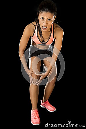 Sport woman holding injured knee suffering pain in ligaments injury or pulled muscle Stock Photo