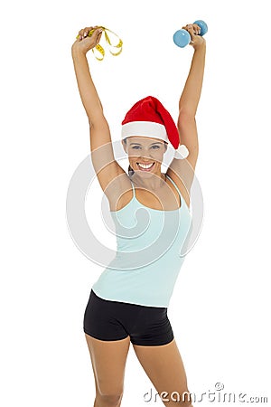 Sport woman in santa Christmas hat holding weight dumbbells and measure tape Stock Photo