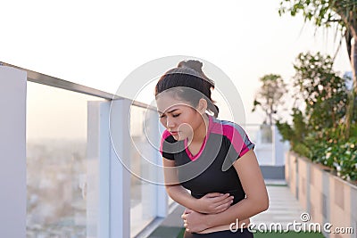 Sport woman stomachache in a park Stock Photo