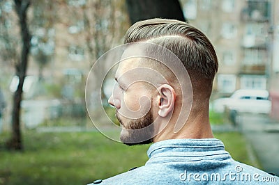 Sport young man with a modern trendy fade profile haircut for barbershop Stock Photo
