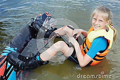 Sportin child riding on a wakeboard on the lake Stock Photo