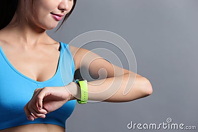 Sporting woman use wearable watch Stock Photo