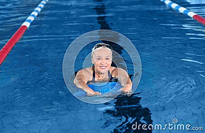 Sportive senior woman in indoor pool Stock Photo