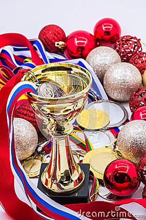 Sports awards and new year`s toys, medals and cups, red Christmas balls, winter competitions, new year`s holidays Editorial Stock Photo