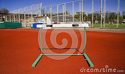 sports barrier. Red treadmills at the stadium. Red racetracks on the sports arena. Stock Photo