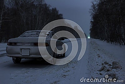 Sports car at night on a winter icy road in the absence of traffic Stock Photo