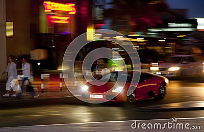 A sports car sweeps along a night street, Dubai 2013 Editorial Stock Photo