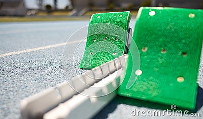 Sports closeup, starting blocks and running track, field or pitch for training, exercise or sprint in arena. Start Stock Photo