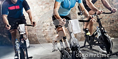 Sports clothing people riding exercise bikes Stock Photo