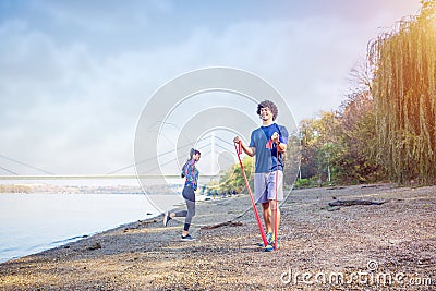 Sports couple training outdoors-man working out with resistance Stock Photo