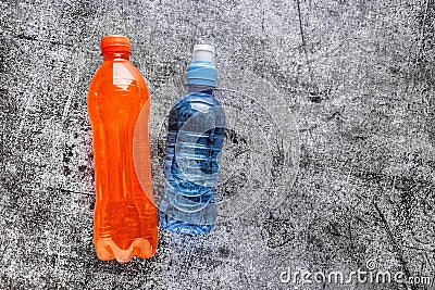 Sports Energy Drinks, sport beverage on a gray concrete background. It usually contains salt and sugar and maintains optimal Stock Photo