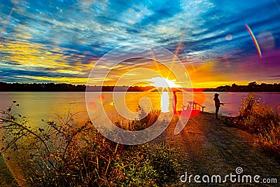 Sports Fishermen at Sunset early fall with beautiful skyline over Ed Zorinsky lake Omaha Nebraska Stock Photo