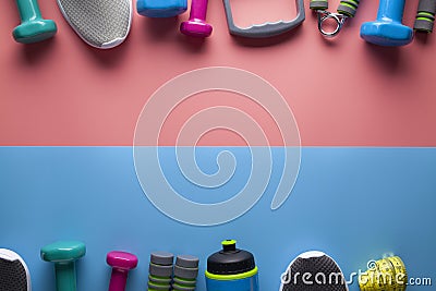 Sports and fitness equipment on a two-colored pastel background Stock Photo