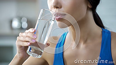 Sports girl drinking crystal clear water, restoring aqua balance after training Stock Photo