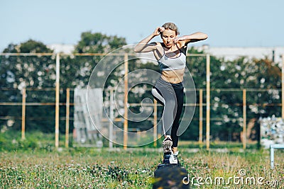 Sports girl runs and jumps over obstacles Stock Photo