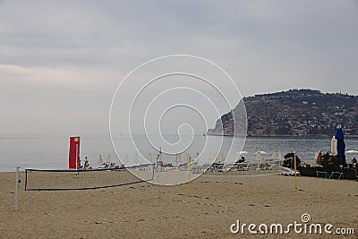 Sports grounds on a deserted beach against the backdrop of the sea and rocks, evening, Alanya, Turkey, October 2021 Stock Photo