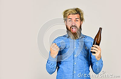 Sports lover cheer up. mature man holding glass bottle of beer. drunk hipster male craft bottled beer. happy man hold Stock Photo