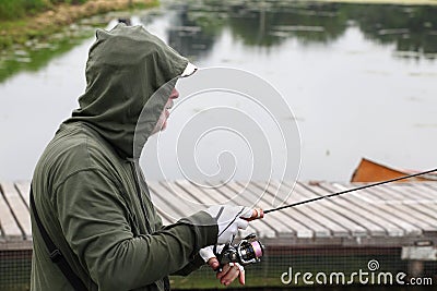 Sports trout fishing. Fisherman with fishing line. Editorial Stock Photo