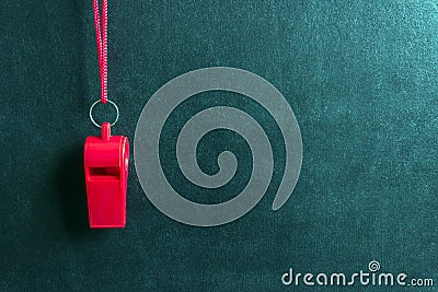 Sports whistle on a red lace.Concept- sport competition, referee, statistics, challenge, friendly match. Stock Photo