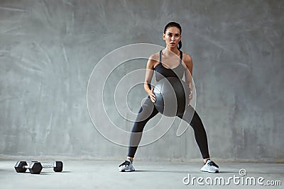 Sports Woman In Fashion Sportswear Squats With Fitness Ball Stock Photo