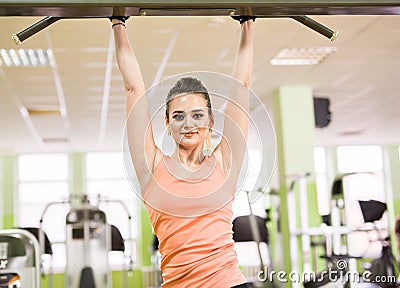 Sports young beautiful woman pulled out in the gym. The concept of fitness, sport and lifestyle. Stock Photo