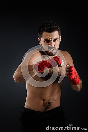 Boxer throwing a fierce and powerful punch. Stock Photo