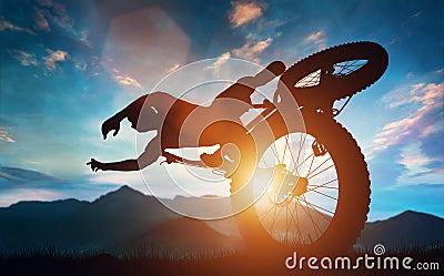 Sportsman doing bike stunts in mountains. Stock Photo