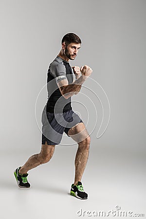Sportsman fighter isolated over grey wall background Stock Photo