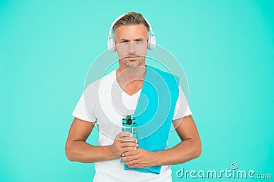 Sportsman gym instructor with water bottle and headphones. Healthy lifestyle. Gym aesthetics. Mature but still in good Stock Photo