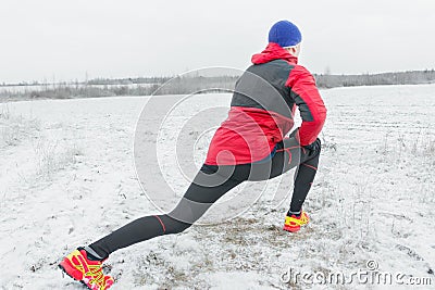 Sportsman making physical exercises in red protective nylon jacket Stock Photo