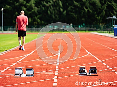 Sportsman walk on the running tracks after training. course. Stock Photo