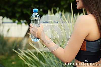 Sportswoman with bottle of water, closeup Stock Photo