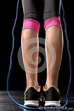 Sportswoman exercising with skipping rope Stock Photo