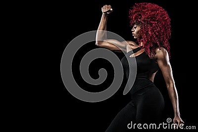 Sporty beautiful afro-american model, woman in sportwear makes fitness exercising at black background to stay fit Stock Photo