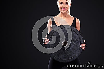 Sporty beautiful woman doing workout exercising at black background to stay fit. . Stock Photo