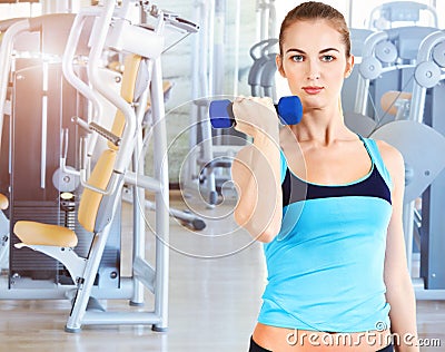 Sporty female doing physical exercise in gym Stock Photo