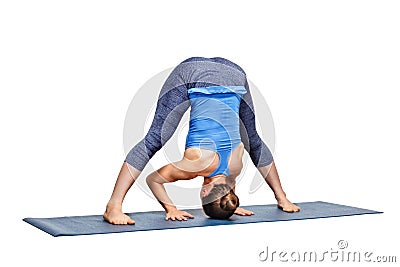 Sporty fit woman practices Ashtanga Vinyasa yoga asana Prasarita Stock Photo