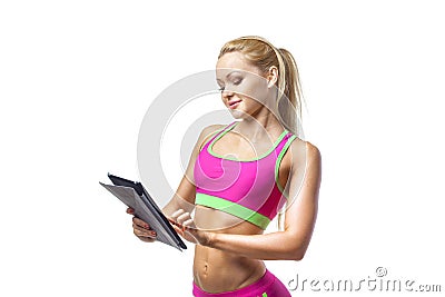 Sporty fitness girl using tablet pc on isolated white background Stock Photo