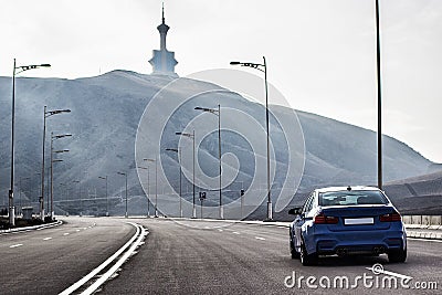 Sporty German bmw m3 sedan on a winding mountain road. fr Stock Photo