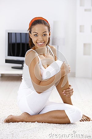 Sporty girl on living room floor Stock Photo