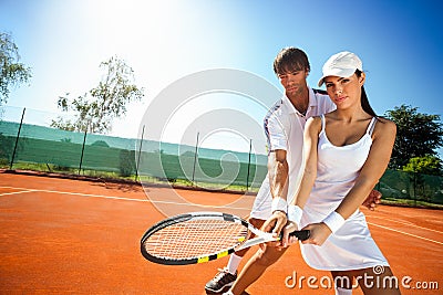 Sporty girl practice tennis with coach Stock Photo