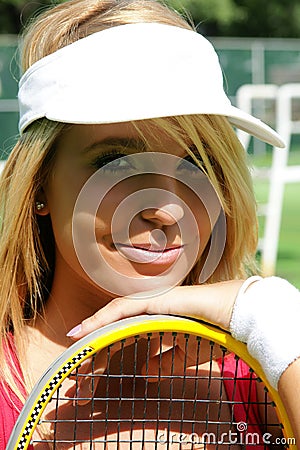 Sporty girl in tennis cap smiling Stock Photo