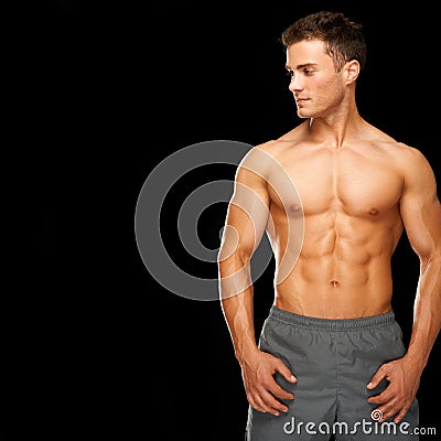 Sporty and healthy muscular man isolated on black Stock Photo