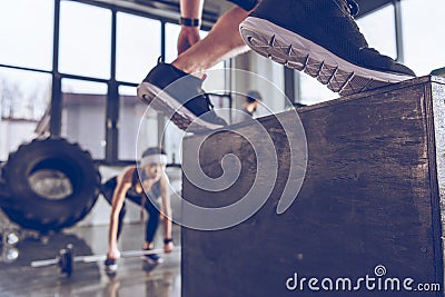 Sporty people exercising at cross fit gym workout Stock Photo