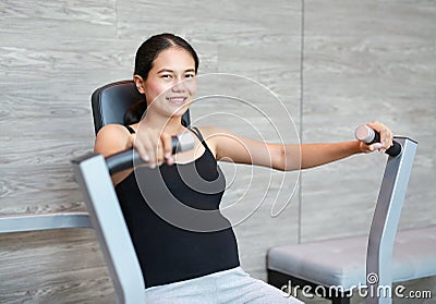 Sporty pregnant woman exercising in fitness room with smiling and looking at camera Stock Photo