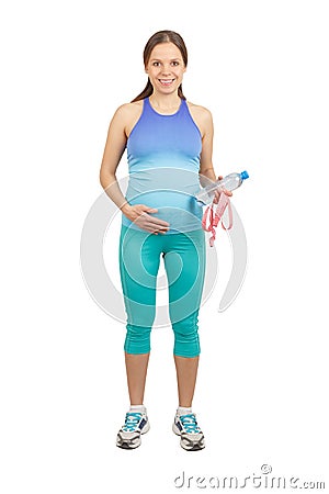 Sporty pregnant woman in the sports clothes with tape measure and a bottle of water in the hands, isolated Stock Photo