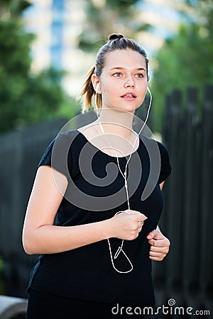 Girl jogging outdoor with music Stock Photo